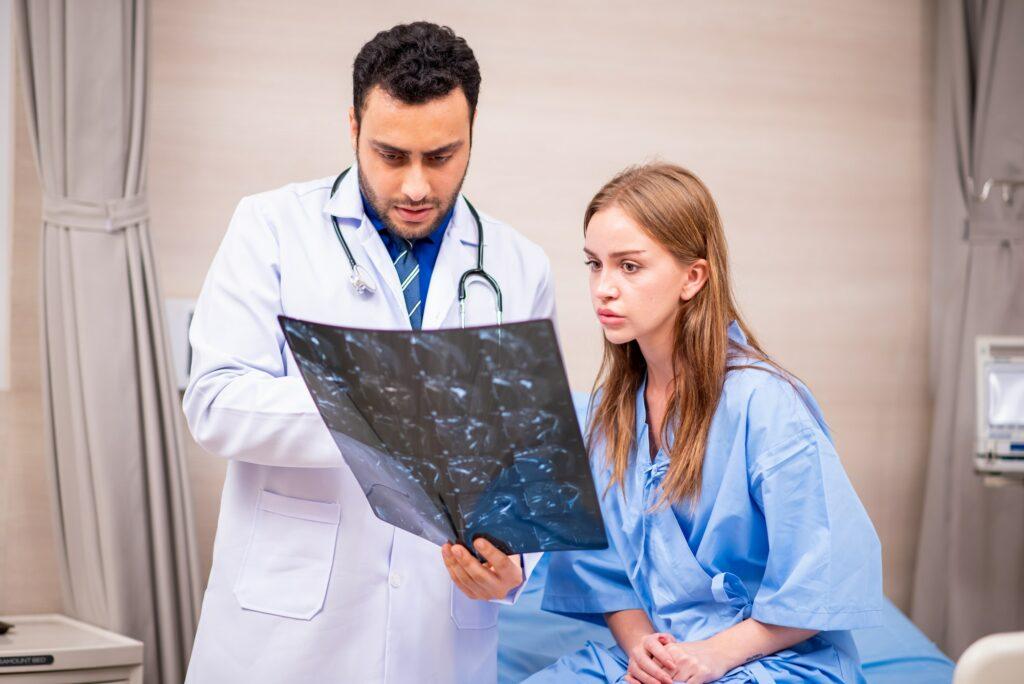 Doctor examining patient in hospital.